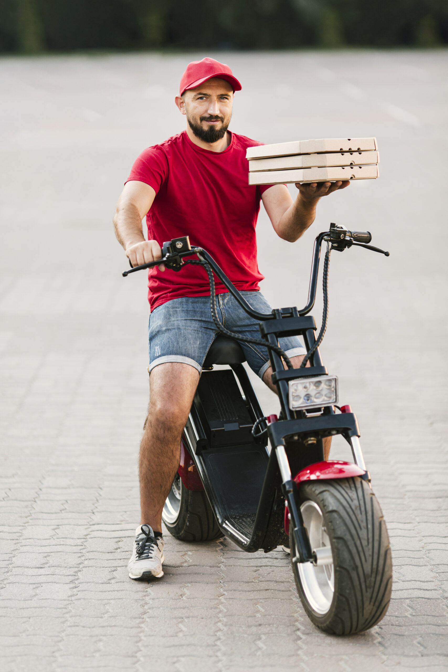 full shot delivery guy holding pizza boxes